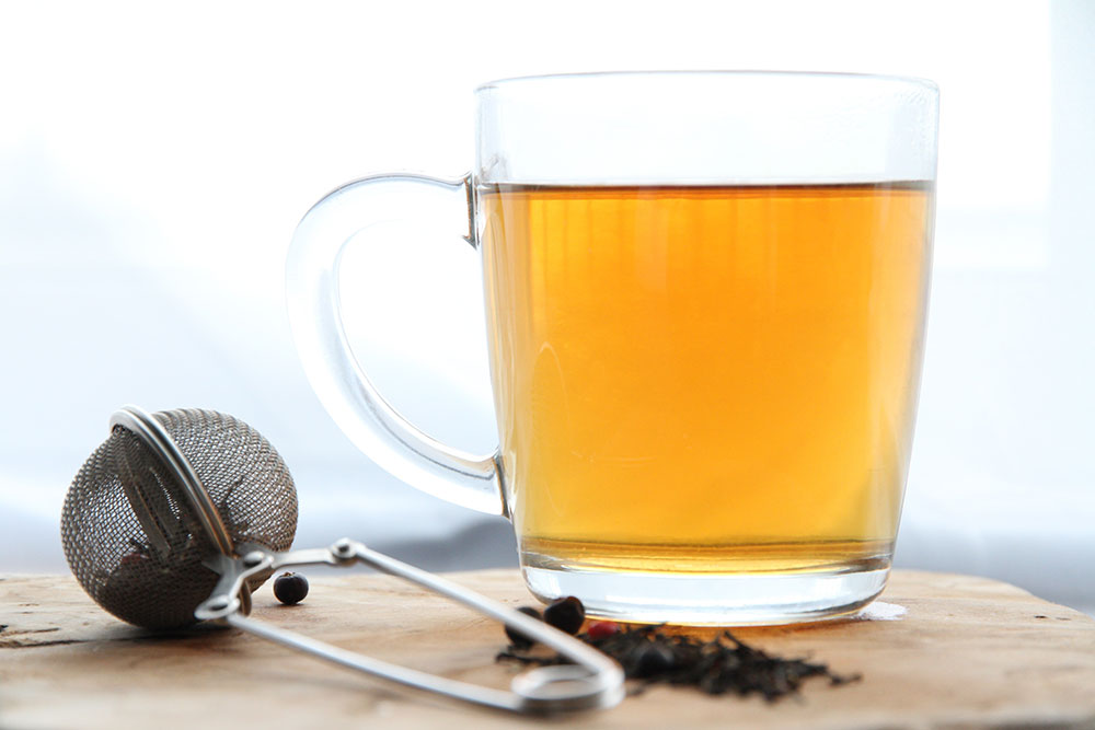 brewed tea with tea leaves in filter to show tea caffeine vs coffee 