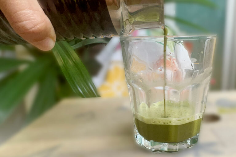Using a milk frother for matcha and pouring the matcha tea into a glass