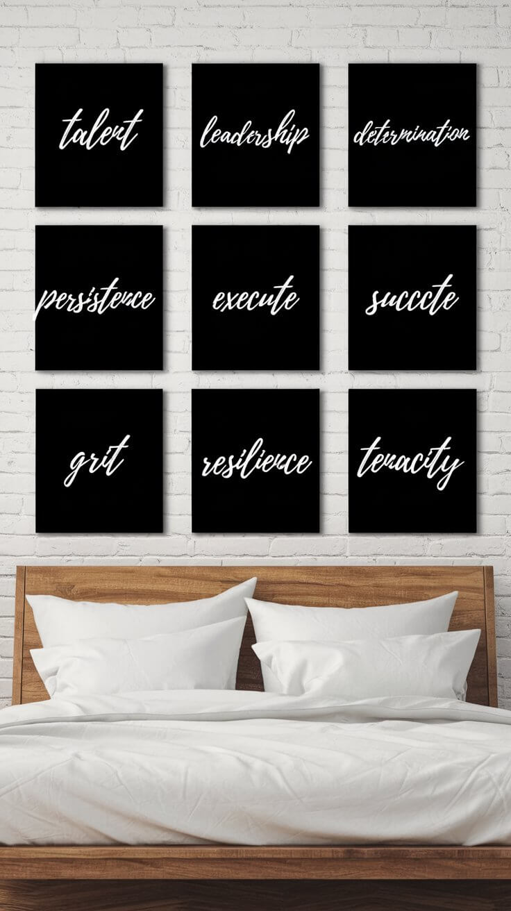 Nine motivational word art pieces on a white brick wall above a wooden bed with white bedding. Words include resilience, tenacity, and leadership.