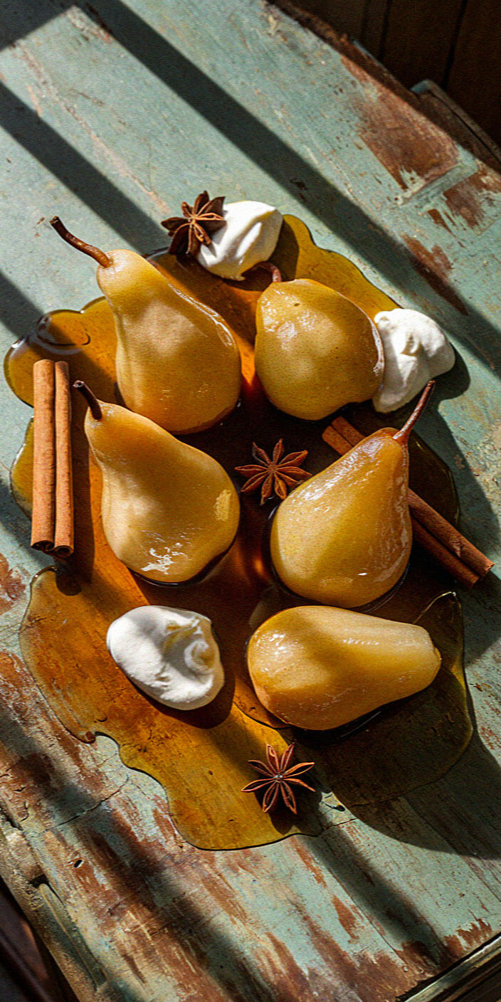 Pears poached in syrup with cinnamon, star anise, and dollops of cream on a rustic wooden table under dappled sunlight.