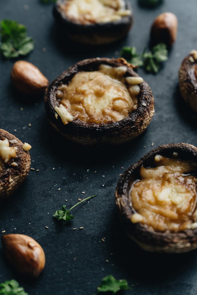 Delicious gourmet stuffed mushrooms with melted cheese and fresh parsley.
