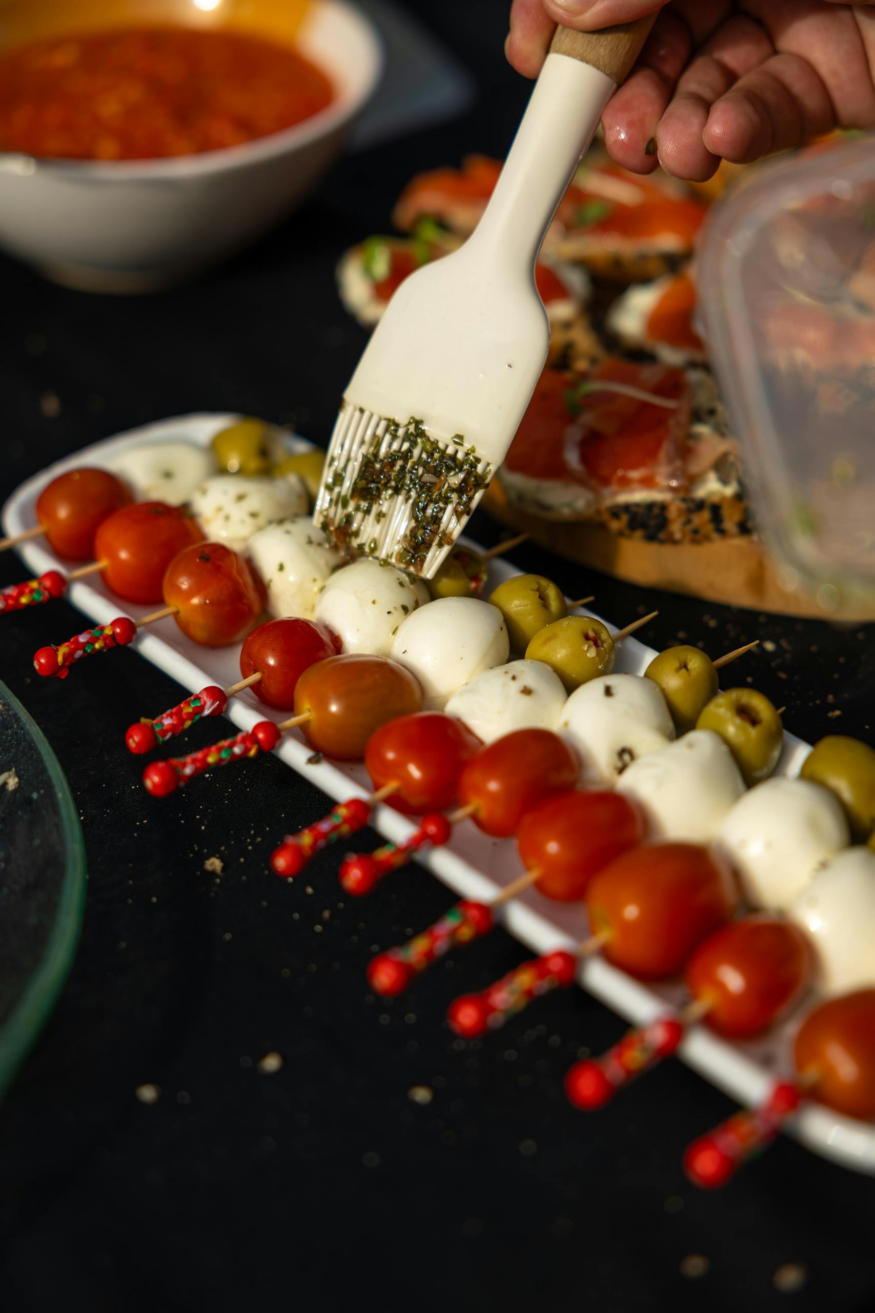 Flavorful caprese skewers with cherry tomatoes, mozzarella, olives, and herbs. Perfect for parties.